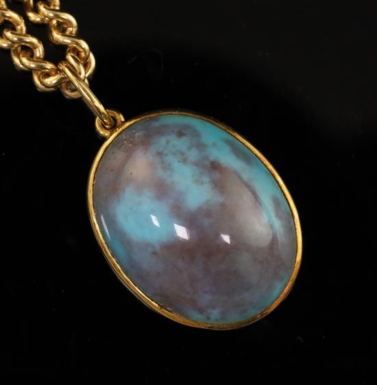 A modern 18ct. gold and turquoise set oval pendant on an 18ct gold chain, pendant 20mm.